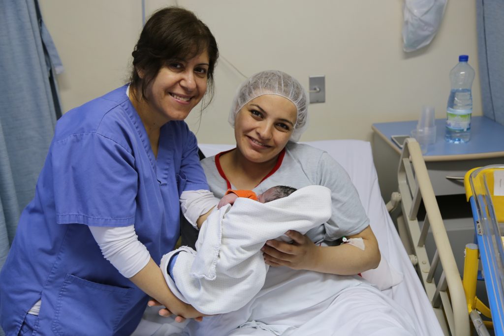 nurse, mom and newborn baby